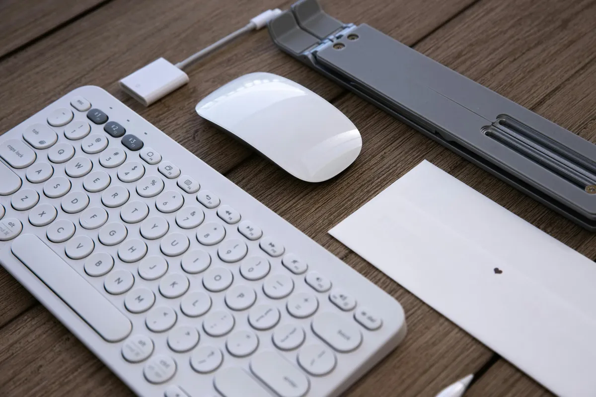 A Logitech MK540 Advanced full-size wireless keyboard and bundled M310 mouse on a developer's desk, the all-rounder pick this guide is built around