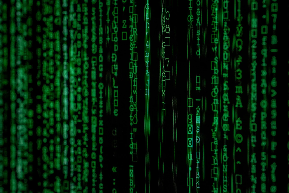 Close-up photograph of a matrix-style code background — ambient stock framing for an article on LLM security and prompt injection
