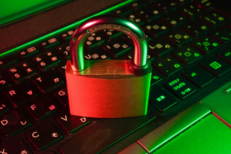 A red padlock resting on a black computer keyboard — ambient framing for the LLM security topic; not a depiction of any specific prompt-injection exploit
